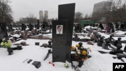 Snow covers the grave of lawyer Sergei Magnitsky with his portrait on the tomb at the Preobrazhenskoye cemetery in Moscow in December.