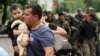 A man carries his son as he leaves his apartment building during an ongoing shoot-out between pro-Russian militants and border guards defending the Federal Border Headquarters in Luhansk on June 2.