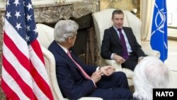 NATO Secretary-General Anders Fogh Rasmussen (right) meets with U.S. Secretary of State John Kerry in Brussels on April 22.