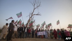 Supporters of Pakistan's Tehreek-i-Insaf (Movement for Justice) hold party flags and shout anti-American slogans during a November 28 demonstration in Islamabad against the NATO cross-border attack from two days earlier.