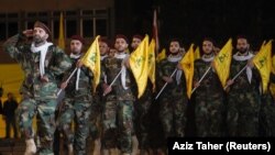 Members of Hezbollah march with party's flags during a rally marking al-Quds Day, (Jerusalem Day) in Beirut, Lebanon May 31, 2019.