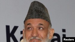 India -- Afghan President Hamid Karzai sits before addressing a gathering at The Third R K Mishra Memorial Lecture organised by Observer Research Foundation in New Delhi, 04Oct2011