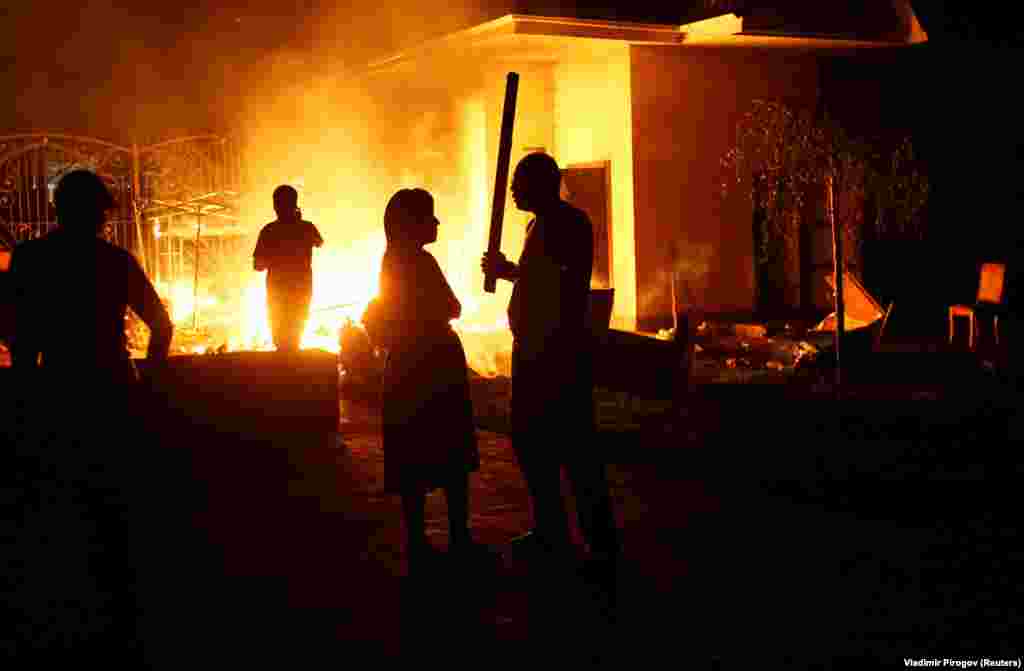 A fire rages in the compound as supporters of the ex-president arm themselves with sticks.&nbsp;