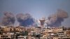 SYRIA -- Smoke rises above rebel-held areas of the city of Daraa during reported airstrikes by Syrian regime forces on July 5, 2018.