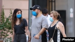 Armenia -- People wear faces masks on a street in Yerevan, August 11, 2020.