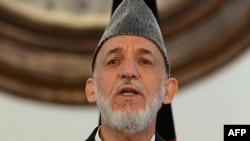 Outgoing Afghan President Hamid Karzai addresses a gathering of government employees at the Presidential Palace in Kabul, September 23, 2014.