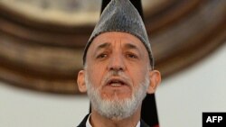 Outgoing Afghan President Hamid Karzai addresses a gathering of government employees at the Presidential Palace in Kabul, September 23, 2014.