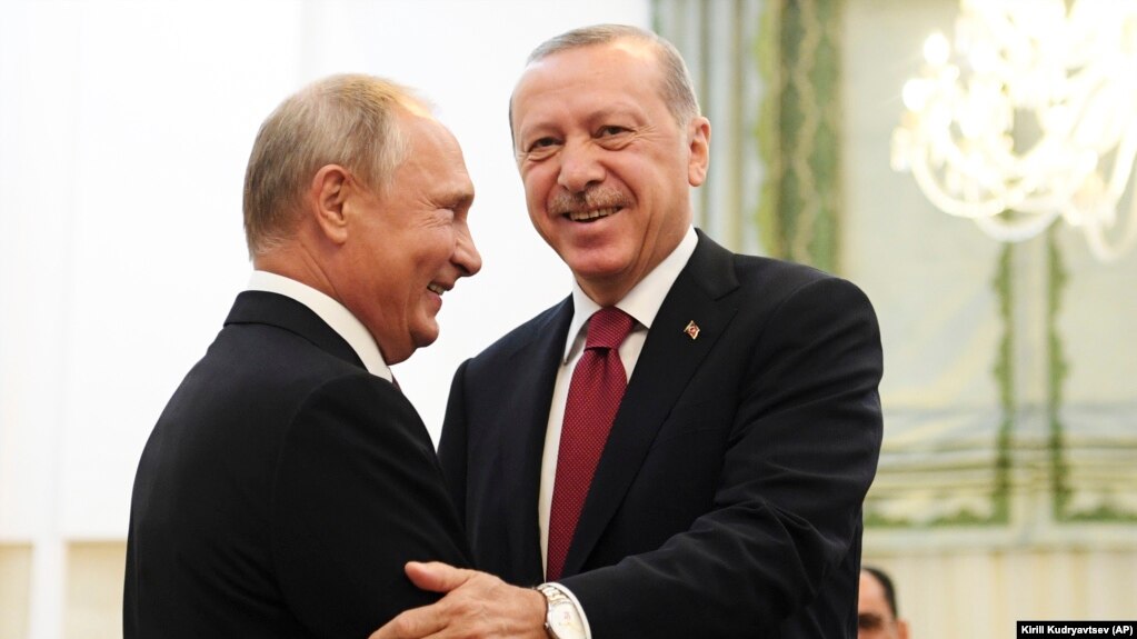 Turkey's President Recep Tayyip Erdogan, right, and Russia's President Vladimir Putin, greets each other in Tehran, Iran, prior to their talks as part of Russia-Iran-Turkey summit to discuss Syria, Friday Sept. 7, 2018.