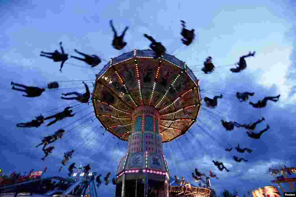 People swing on a ride at the annual Calgary Stampede festival in Canada. (epa/Mohammed Badra)