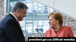 German Chancellor Angela Merkel meets with Ukrainian President Petro Poroshenko in Berlin on April 12.