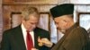 Afghan President Karzai (right) presents President Bush with a medal in Kabul.