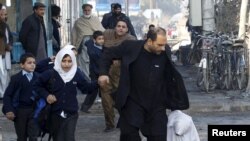 A school girl falls as she and others run after a blast near the Pakistani consulate in Jalalabad on January 13.