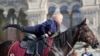 A young girl competes in the children&#39;s trick and fancy riding competition at the 2019 Spasskaya Tower International Military Music Festival and Tattoo in Red Square, Moscow. (TASS/Gavriil Grigorov)