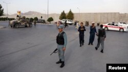 Afghan policemen arrive at the site of a deadly blast in Kabul, Afghanistan, on July 15.