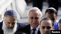 Former Israeli President Moshe Katsav (center) is surrounded by lawyers and relatives as he arrives at a district court for his sentencing in March.