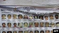 A banner with the pictures of the 33 miners trapped in the San Esteban gold and copper mine in Copiapo