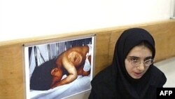 دختر ایرانی ۱۷ ساله که عکس او در سال ۱۹۸۷ در شهر شیمیایی‌شده سردشت گرفته شده است. تصویر روی دیوار نیز عکس او به هنگام بستری بودن در بیمارستان است. (عکس: AFP)