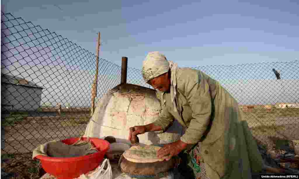 Making bread in a tandoor oven.