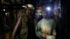 An injured coal miner leaves after he was trapped inside a coal mine in Zenica, Bosnia-Herzegovina, on September 5. Five miners died in the mine following an earthquake. Twenty-nine miners who were trapped were rescued.