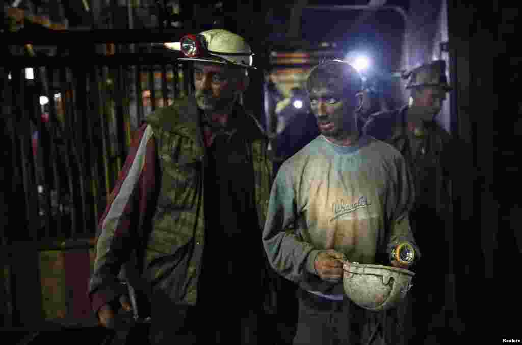 An injured coal miner leaves after he was trapped inside a coal mine in Zenica, Bosnia-Herzegovina, on September 5. Five miners died in the mine following an earthquake. Twenty-nine miners who were trapped were rescued.