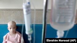 HRW says that some of the worst affected by sanctions were "Iranians who have rare diseases and/or conditions that require specialized treatment and are unable to acquire previously available medicines or supplies." (file photo of an Iranian boy receiving chemotherapy in June)
