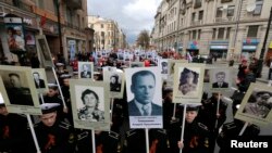 Russian cadets whose relatives fought in World War II carry their portraits during a parade in St. Petersburg on May 5.