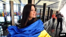 Singer Ruslana Lyzhychko of Ukraine holds a Ukrainian national flag during an interview with AFP at the State Department in Washington in March.