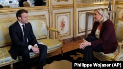 Emmanuel Macron și Marine Le Pen într-o discuție din 2019. Cei doi au fost contra-candidați și la alegerile din 2017.