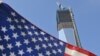 The unfinished One World Trade Center, the flagship of the redeveloped site, is seen behind a U.S. flag on September 7, 2012. The tower, due to be completed in 2014, will rise to 1,776 feet. 