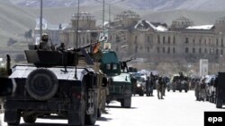 Afghan security forces near the scene in Kabul where militants on March 25 attacked an office of the electoral commission, also near the residence of presidential candidate Ashraf Ghani