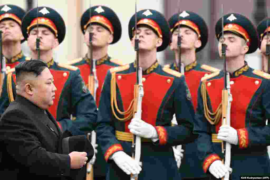 North Korean leader Kim Jong Un walks past honor guards during a welcome ceremony shortly after arriving at the railway station in the Russian port of Vladivostok on April 24.&nbsp;