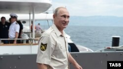 Russian President Vladimir Putin smiles before boarding a mini-submarine in the Black Sea, off the annexed Crimean peninsula.