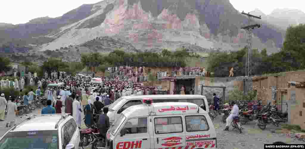 People gather at the scene, near the Afghan border, on September 8. 