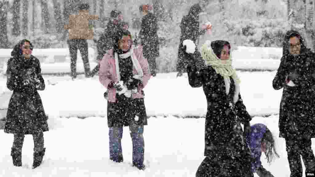 Young people play in the first snow in the city of Rasht, Iran. (IRNA)