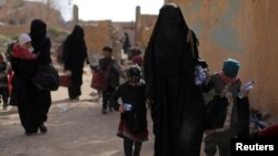 Families of Islamic State fighters surrender in the village of Baghouz in Syria in March 2019.