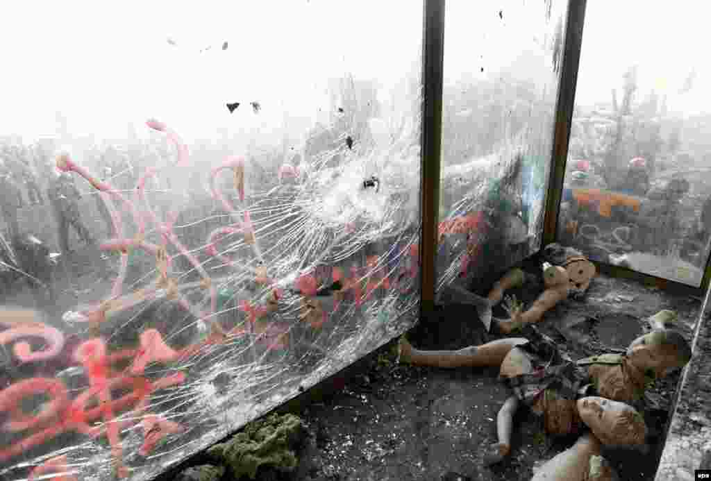Mannequins lie on the ground behind a damaged shop window near the site of clashes between antigovernment protesters and riot police in Kyiv. (Reuters/Vasily Fedosenko) 