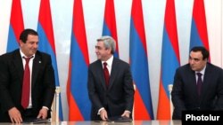 Armenian President Serzh Sarkisian (center), Orinats Yerkir Party leader Artur Baghdasarian (right), and Prosperous Armenia Party leader Gagik Tsarukian (left) signed a coalition agreement in February 2011.