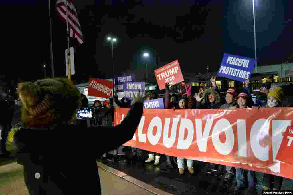 U.S. -- Supporters of US President Donald Trump hold signs and chant slogans as they wait for buses to arrive to take them to Washington, DC, in Newton, Massachusetts on January 5, 2021.