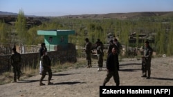 Afghan soldiers at the site of an attack by Taliban militants on a government compound in Ghazni on April 12.