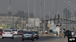Islamic State militants man a checkpoint in Mosul in June (file photo)