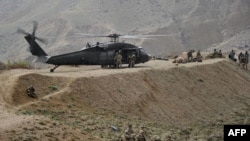 U.S. soldiers are pictured near a UH-60 Black Hawk helicopter during a recovery operation in Nangarhar Province in 2013.