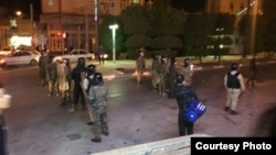 Police gather late on June 30 in the city of Khorramshahr.