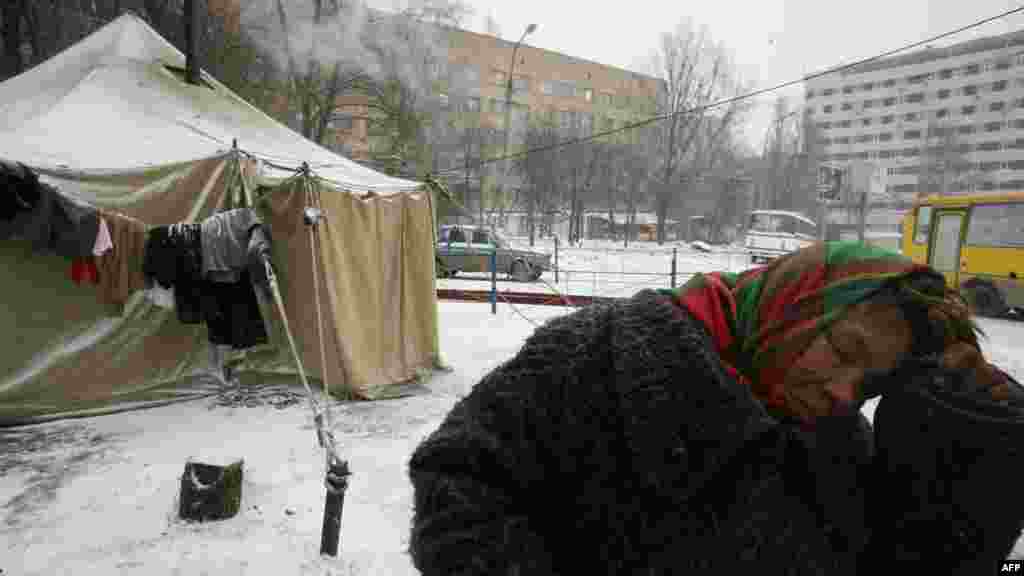 A homeless woman in Ukraine visits one of the newly opened tent shelters in the industrial city of Donetsk.