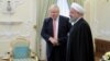 Iranian President Hassan Rohani (right) meets with British Foreign Secretary Boris Johnson in Tehran on December 10.