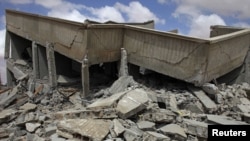 A house lies in rubble after a NATO airstrike near the village of Shal Ghouda in western Libya on August 11.