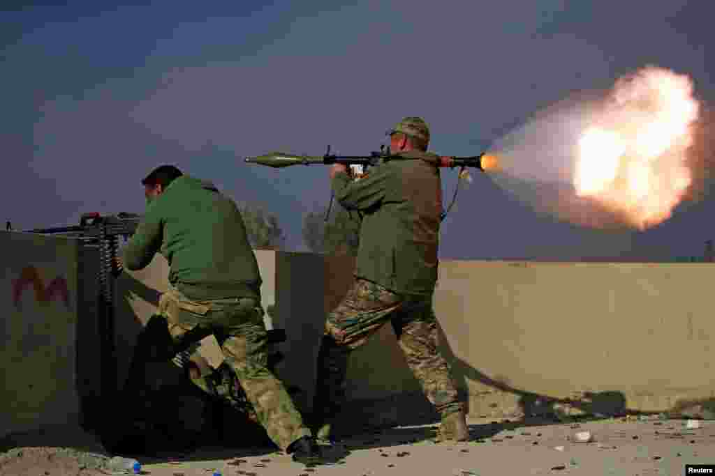 A member of the Iraqi rapid response forces fires a rocket launcher during a battle with Islamic State militants in the district of Yarimja in southern Mosul. (Reuters/Alaa Al-Marjani)