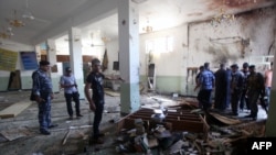 Iraqis inspect the damage at a Shi'ite place of worship after a suicide bomber attacked worshipers during prayers in eastern Baghdad. Shi'ite worshipers are often targeted by IS militants.