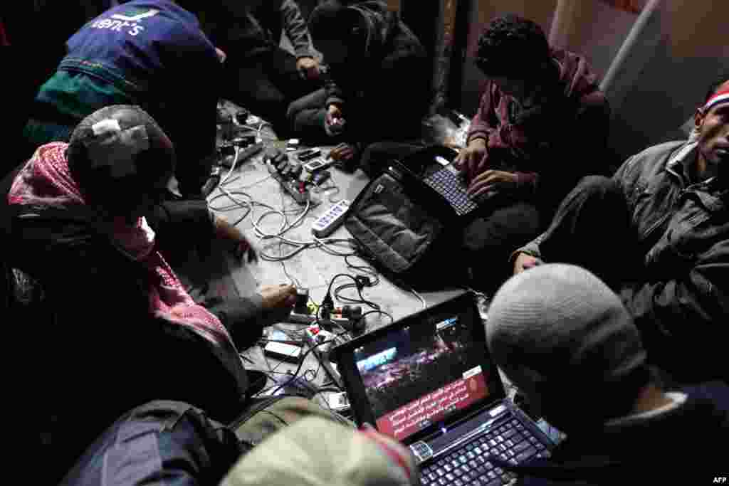 Egyptian antigovernment bloggers work on their laptops from Cairo's Tahrir Square on February 10, 2011.