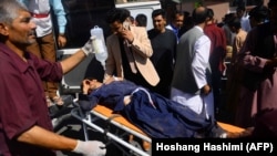 An injured Afghan man is transported on a stretcher after being injured when a bus hit a roadside bomb on the Kandahar-Herat highway, at a hospital in Herat, on July 31.