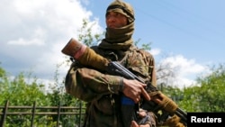 A June 22 photo from the Donetsk region city of Siversk shows a Kalashnikov-carrying separatist identified as Bakhtiyor, a native of Uzbekistan.